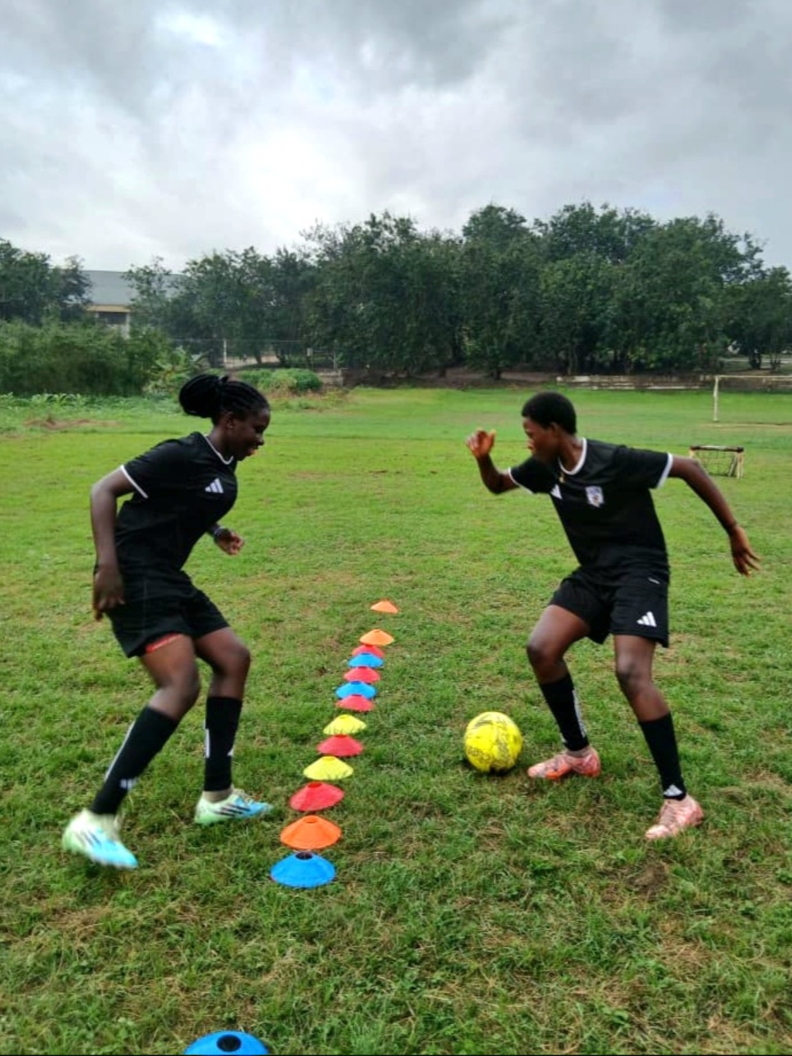 Two Academy players practising footwork beside training cones