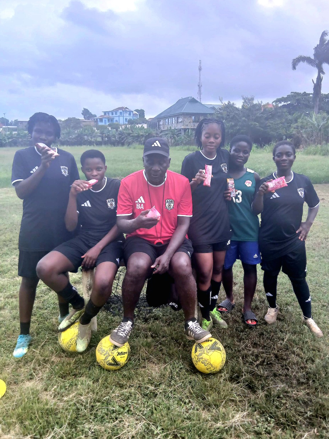 Academy players and coach sharing ice cream