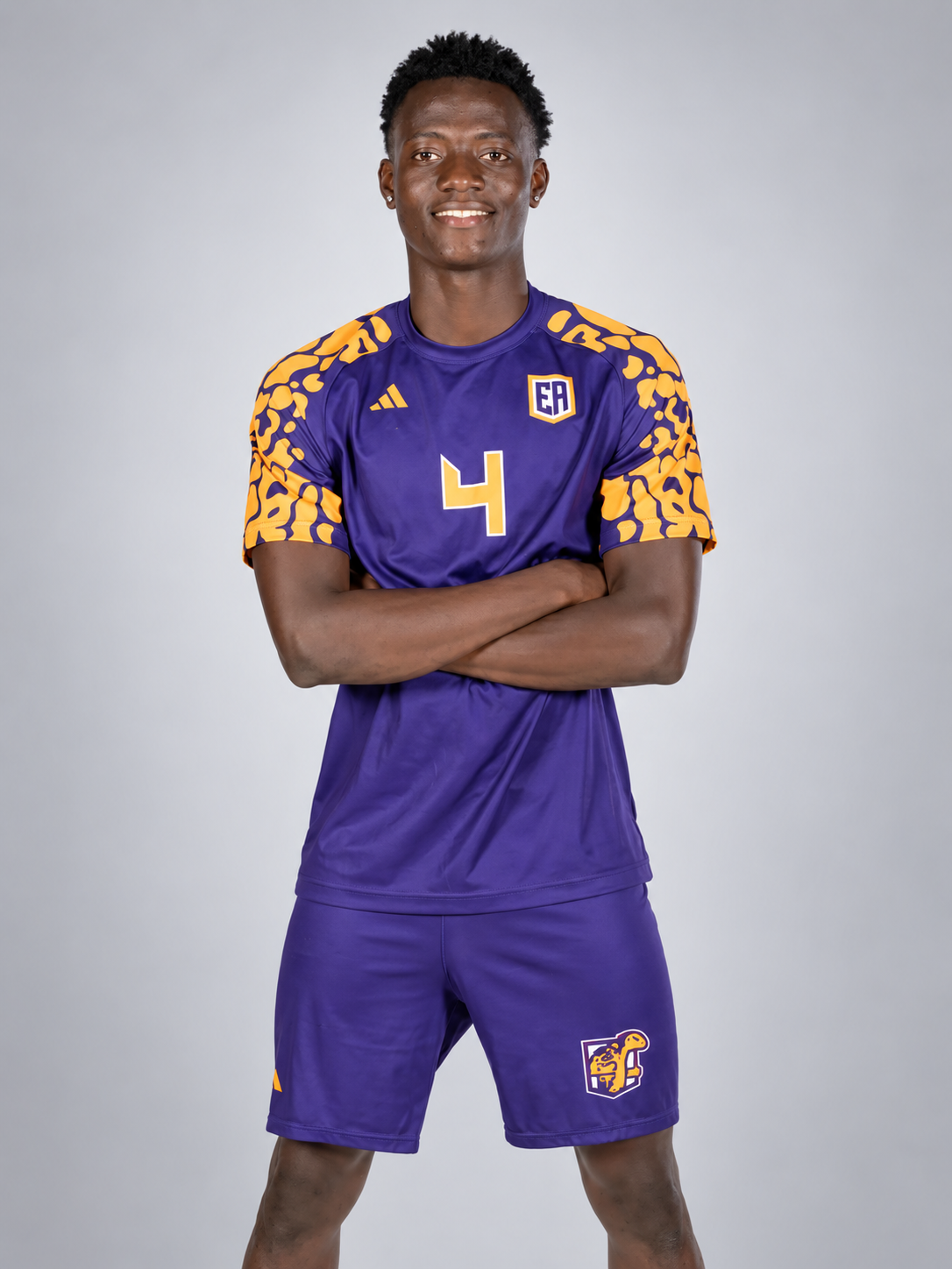 Mujab in his Eastern Arizona football kit against a light grey studio background